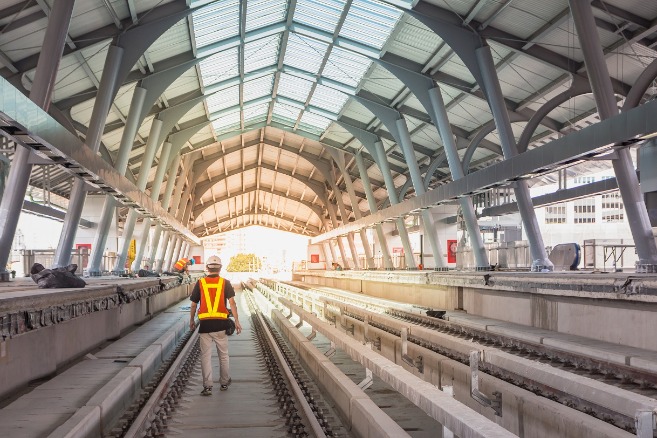 Railway engineers working on a large-scale project inside a station in a big city