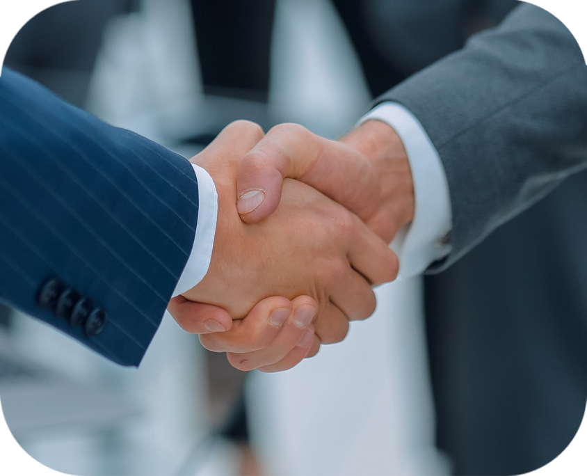 Two hands shaking from a close viewpoint where only the sleeves and hands are visible