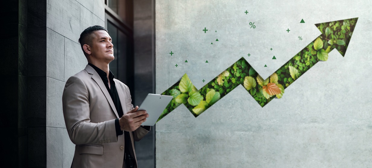 man with a green arrow shooting out of his hand denoting an upward trend