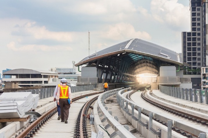 PWAY and rail engineer working on the railway infrastructure outside a station