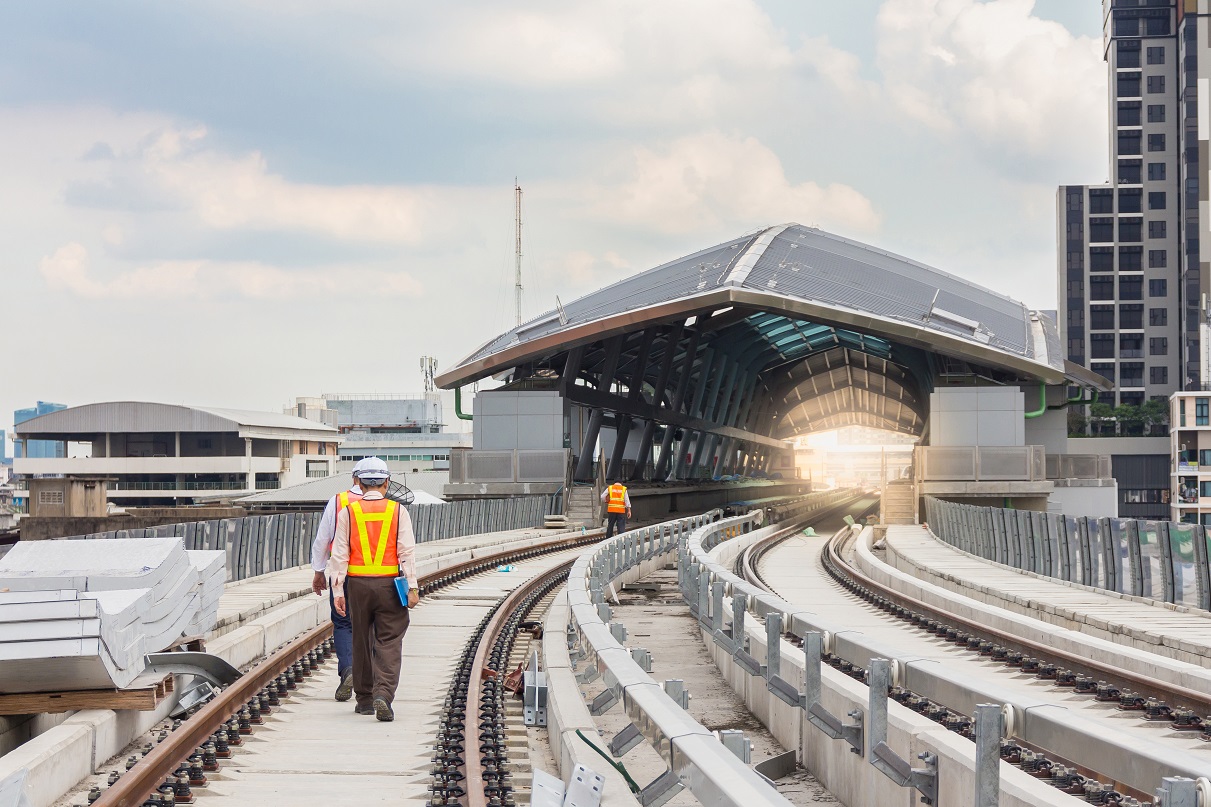 Some engineers walking along the side of a railway construction project