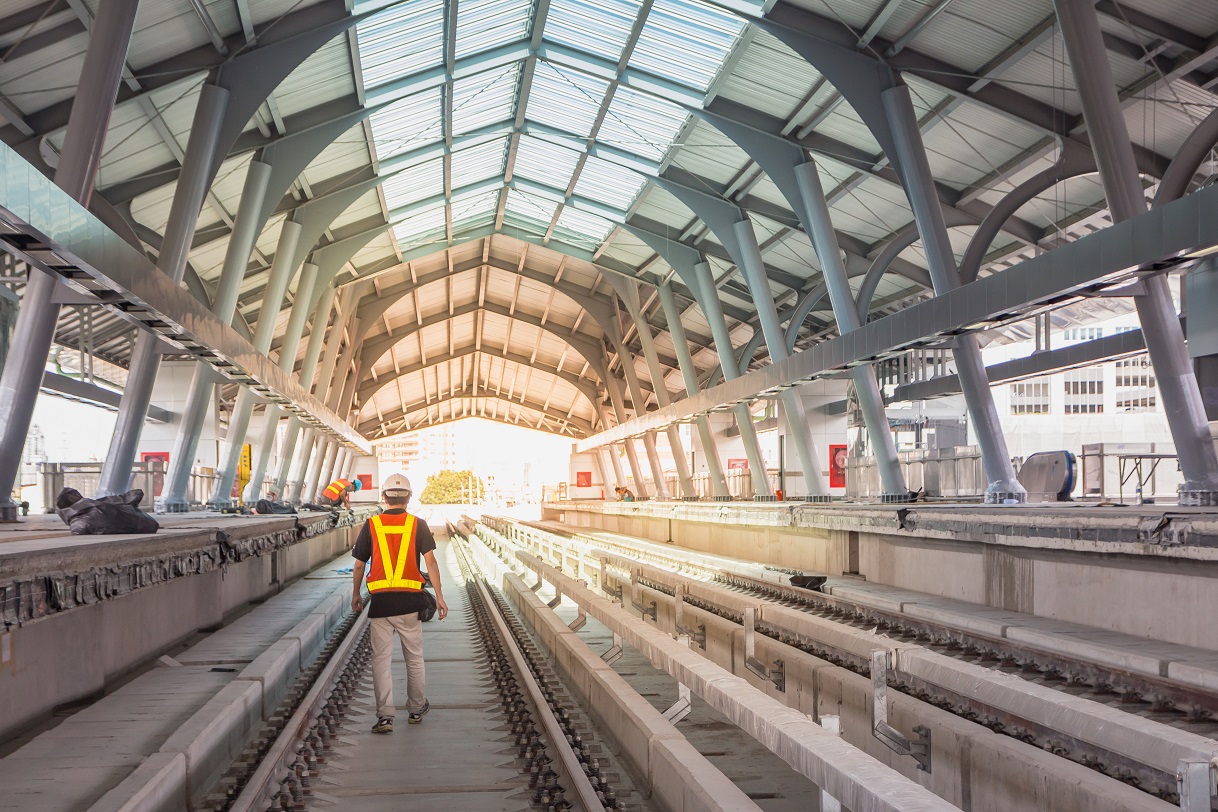 Two civil engineers walking through a railway station which is halfway through refurbishments