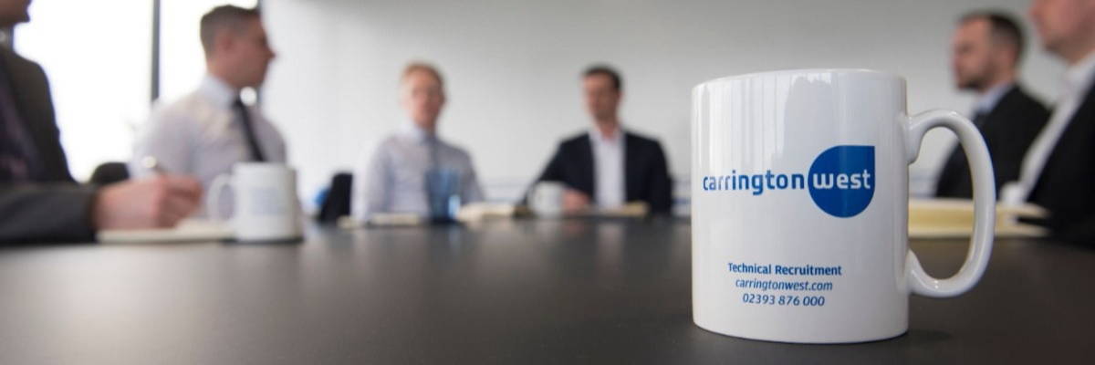Business meeting with Carrington West logo mug